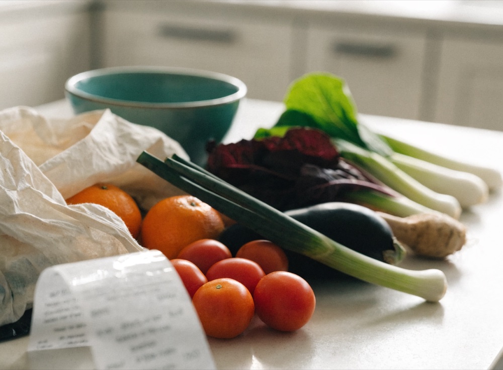 Fresh groceries and a shopping receipt on a kitchen counter