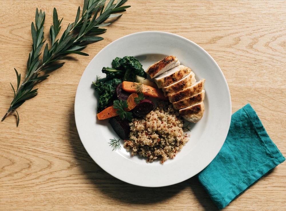 A healthy balanced home-cooked meal of grilled chicken, roasted vegetables and quinoa